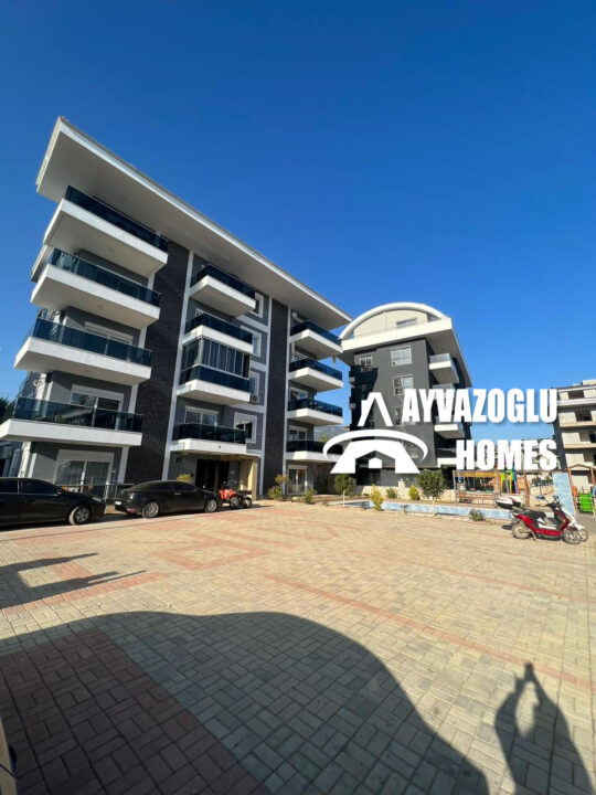 1+1 apartment in Oba area — with balcony, elevator and green area